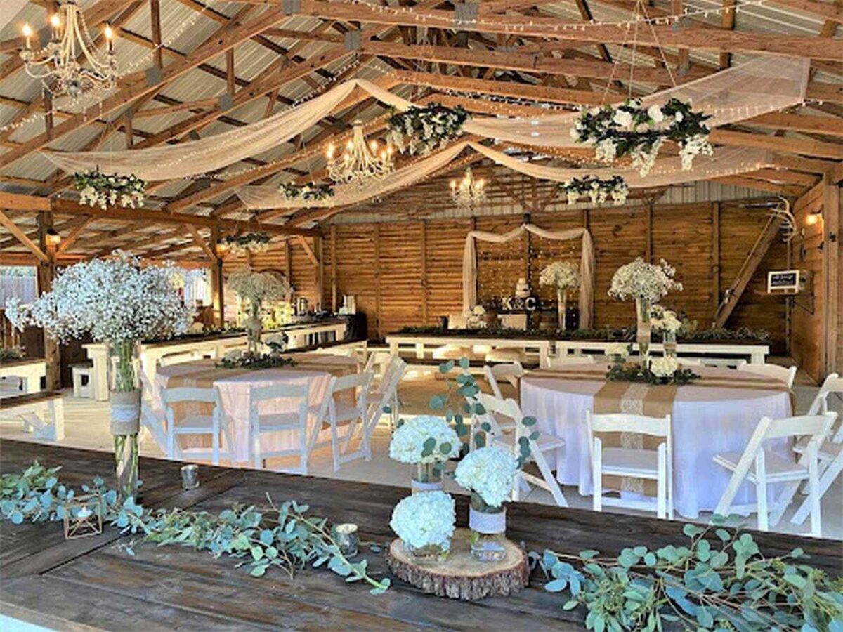 Rustic Barn venue with hanging fabric and suspended floral decoration