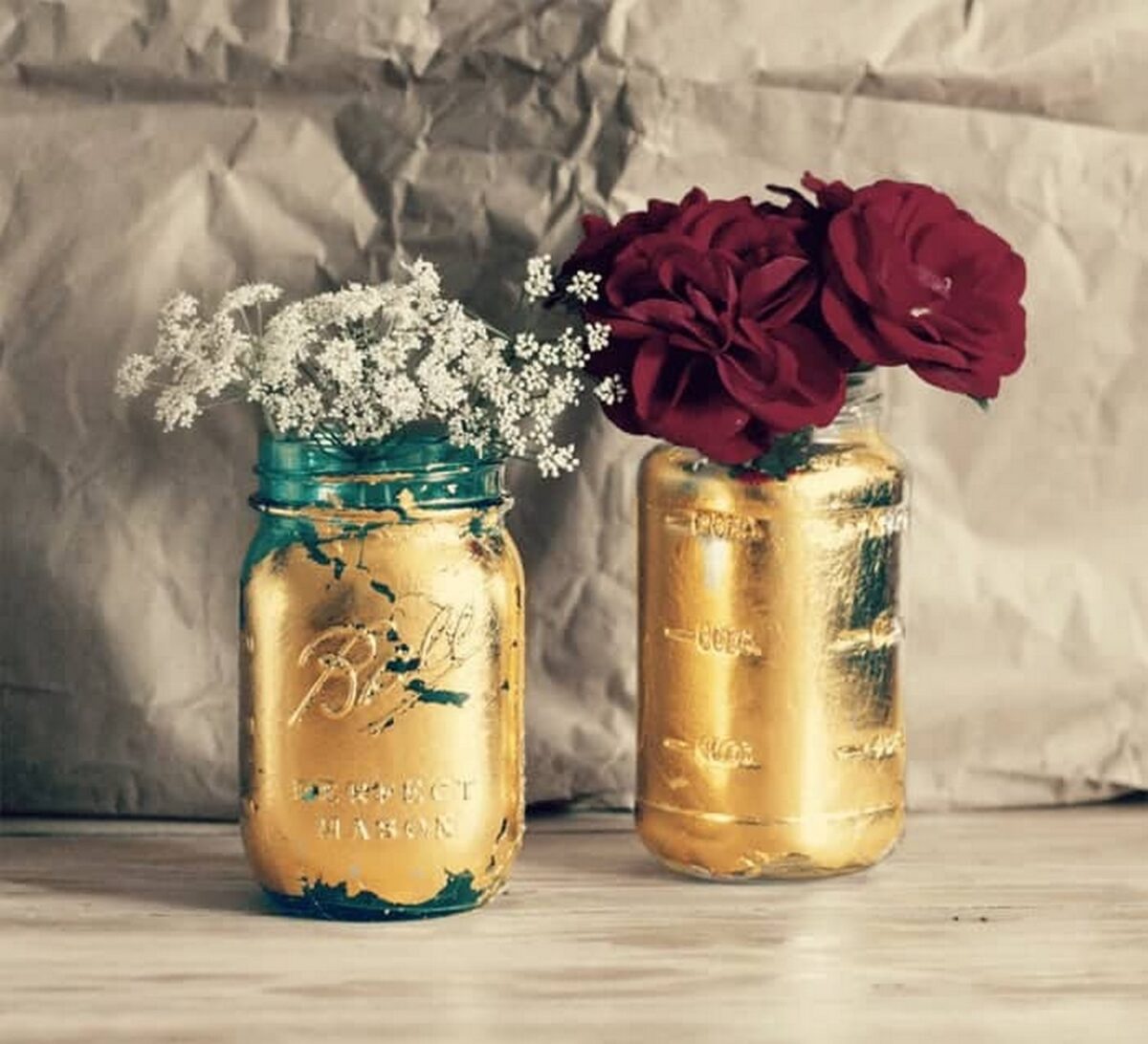 Rose and Baby's Breath flower arrangements in Gold-painted mason jars