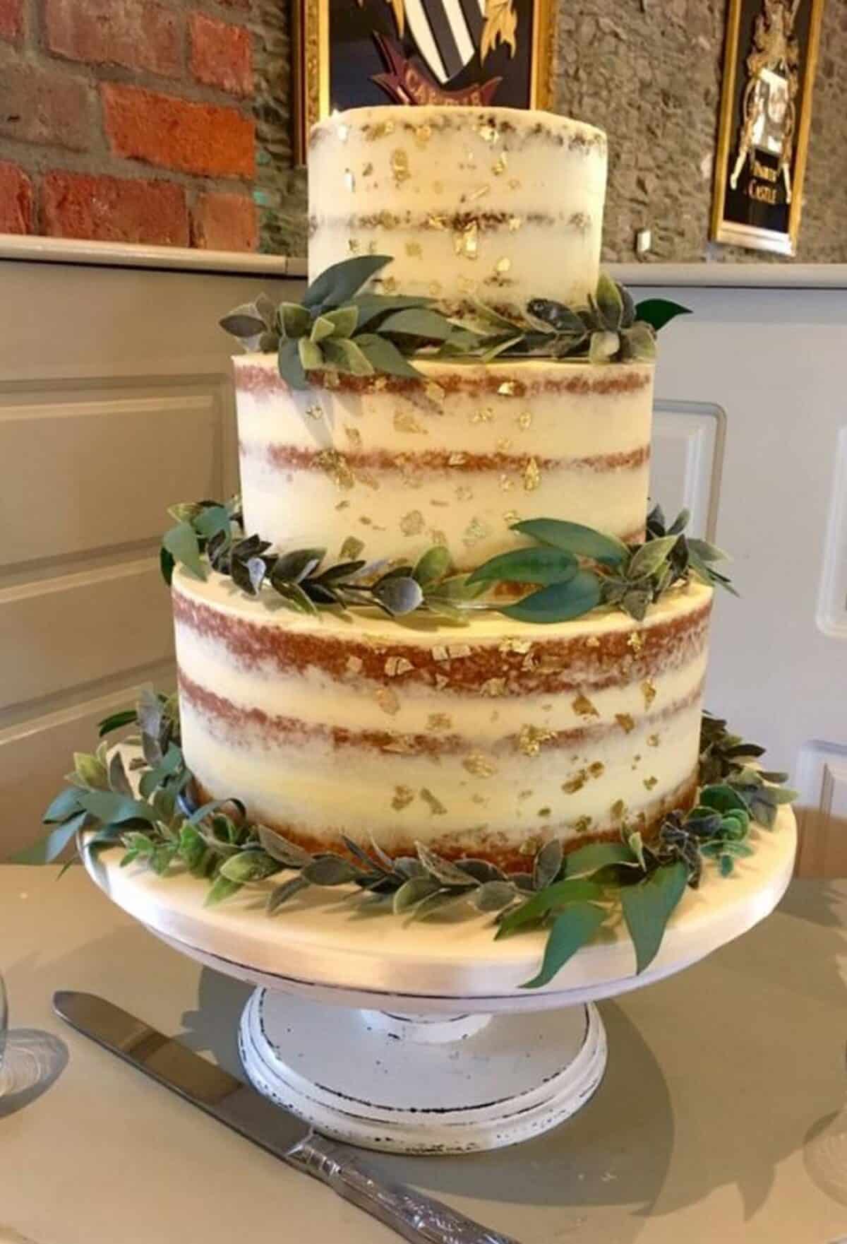 Gorgeous 3-Tiered Naked Wedding Cake with greenery and gold leaf