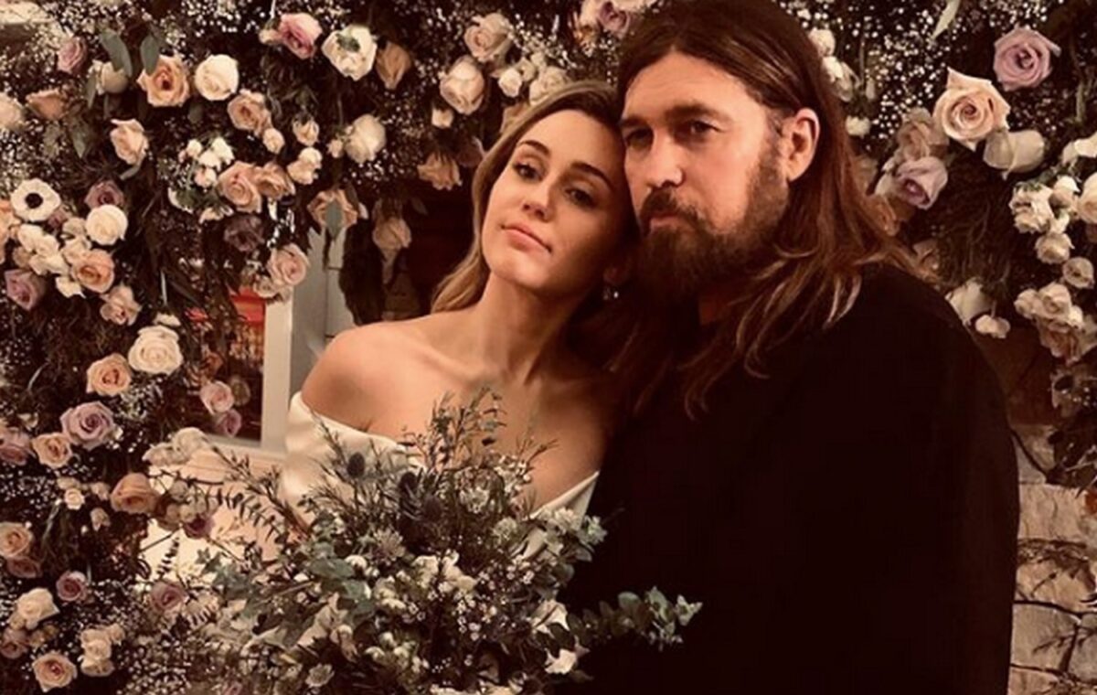 Miley Cyrus and Liam Hemsworth in floral wedding