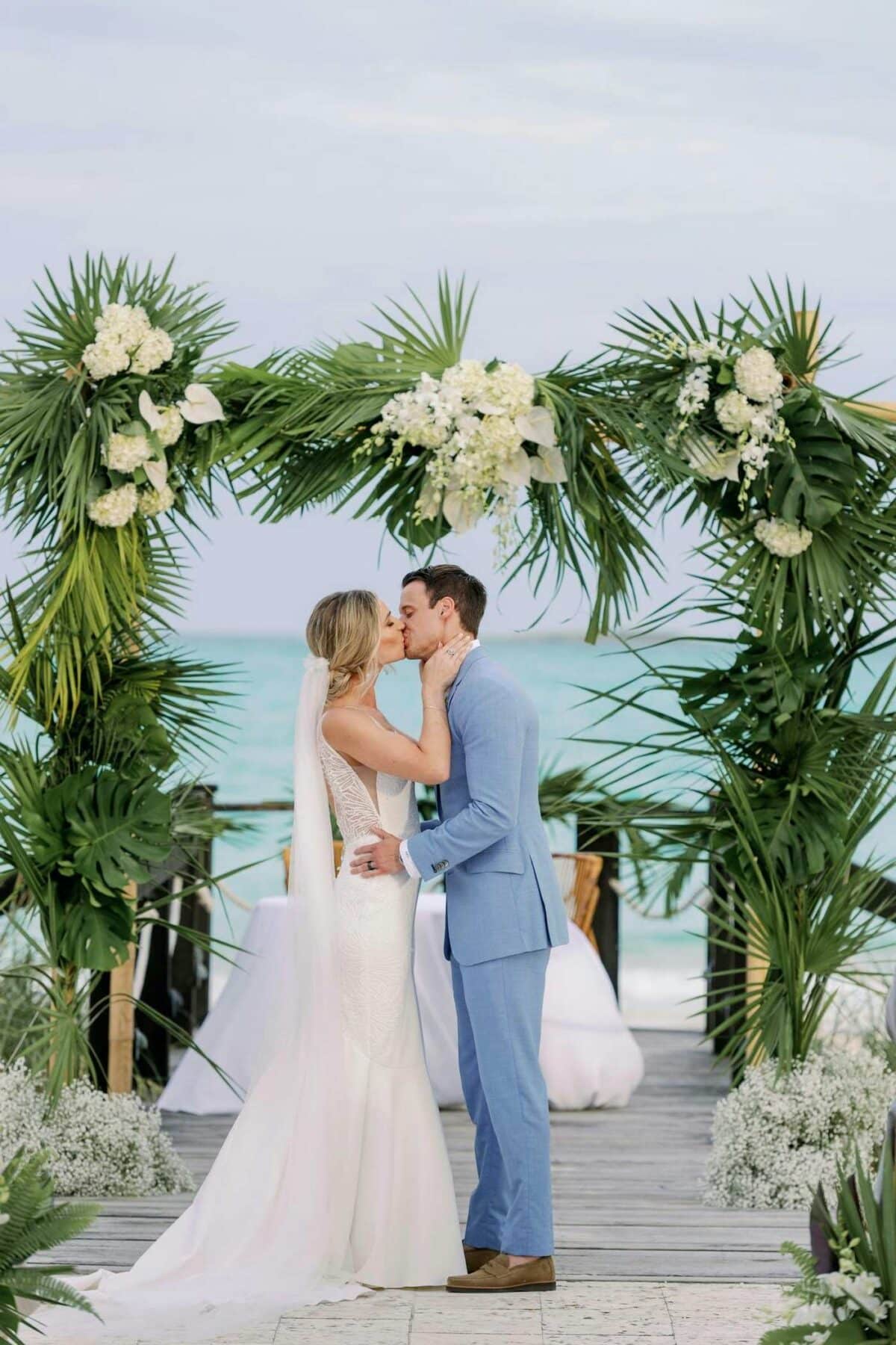 Tropical Greenery Wedding Arch with Hawaiian Hibiscus, palm leaves and more