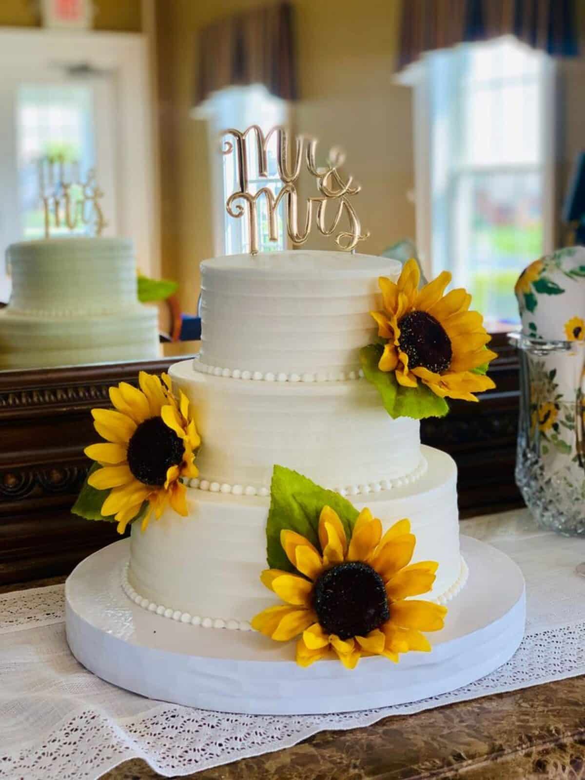 Beautiful White Frosting Wedding cake with edible sunflower sugar flower