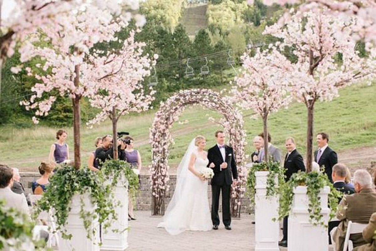 Bride And Groom exchange vows under Cherry blossom trees