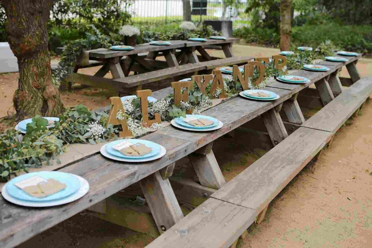 long wooden table with eucalyptus table runner garland